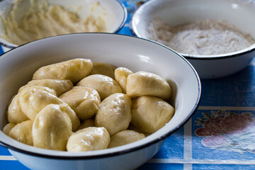 The process of cooking traditional vareniki - textured background. Rural East European cuisine. Dumplings with cottage cheese. Traditional dumplings, pierogi, varenyky