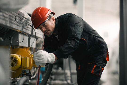 Factory worker. Man working on the cables and wires.