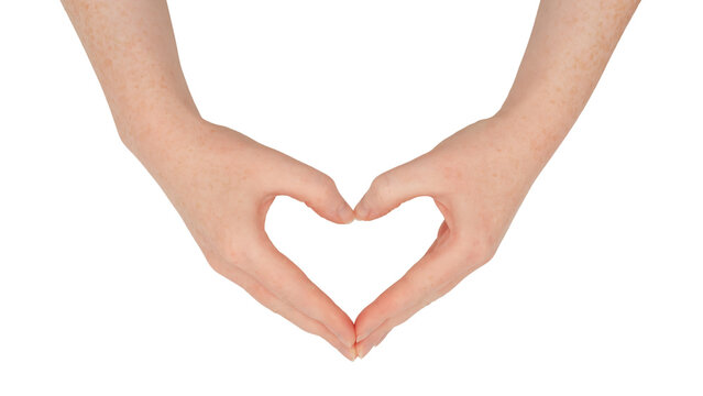 Freckled white hands, making a heart or love shape frame between thumb and index finger with fingers together.  Female hand isolated