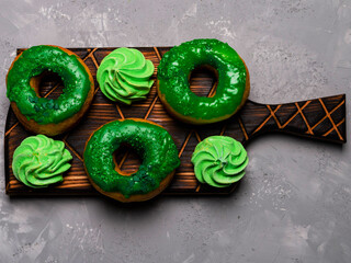 doughnuts and meringues on a grey background