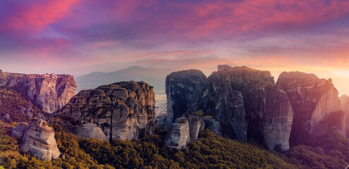 Majestic sunset with colorful sky over the fairytale mountain valley in Greece. Wonderful Picturesque scene. Impressive autumn Landscape. The Meteora monasteries, Greece. Kalambaka. Creative image.