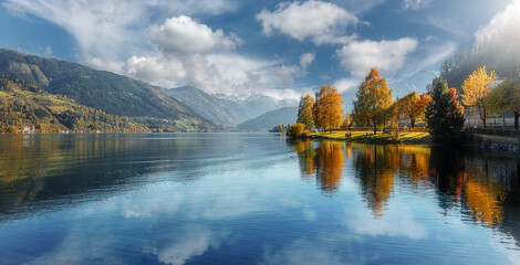 Beautiful Sunny day in Alps. wonderlust view of highland lake With autumn trees under sunlight and...
