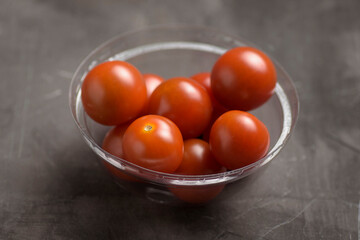 cherry tomatoes in a small plastic bowl