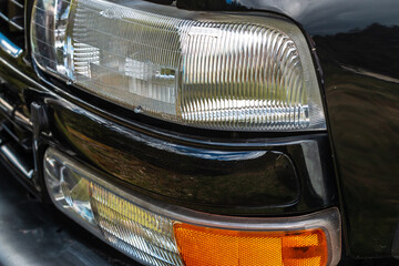 detail shot of the driver's side of a SUV with headlights, indicators, and grille