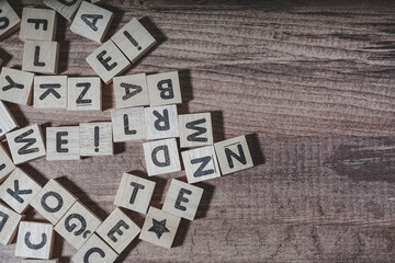 alphabets wooden cubes, wooden background table, view from above.