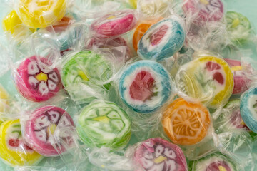 Colorful candy sweets close up. different tastes and drawings of fruits on candies. Candies in transparent wrap