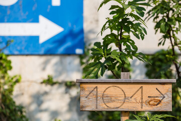 View of wooden board with number 101 and arrow shows direction to home