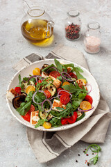 Fresh vegetable salad with arugula, grilled vegetables, sherry tomatoes and  halloumi cheese.Healthy food