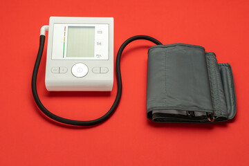 Blood pressure monitoring. Medical test monitor for blood pressure isolated on red background....