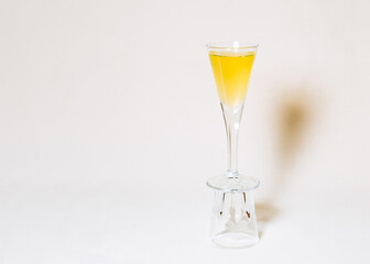 tall glass of infusion infused on a strong red pepper on a light background
