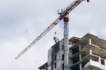 pouring concrete with a crane at the construction site