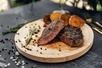 Grilled beef steak ribeye on wooden cutting board.