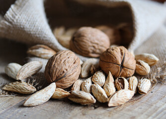 walnuts and almonds on a wooden table close up