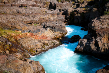 Crystal clear rapid waters of Hraunfossar river in Iceland.