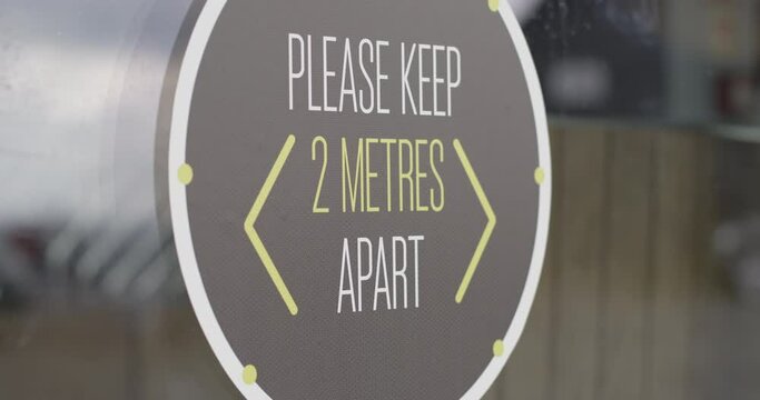 COVID-19 Signage on window of restaurant for social distancing during Corona pandemic, Life after lockdown new normal