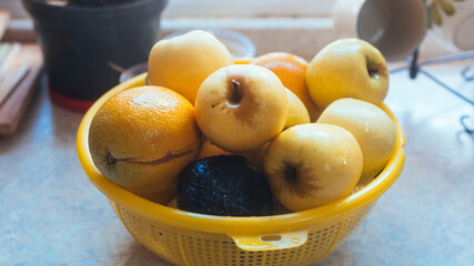 photograph of a set of fruits drying in a strainer