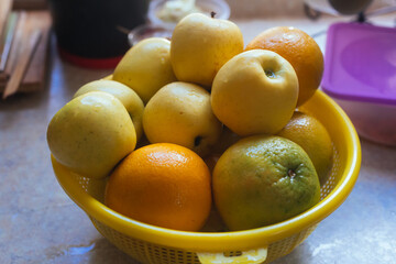 photograph of a set of fruits drying in a strainer
