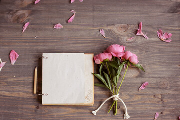 Vintage background, hand made. Pink peony and old scissors, ribbons,  notebook for text. Mothers day.