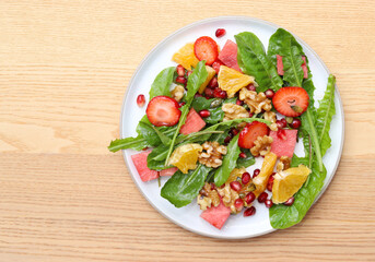 Colourful dandelion salad with fresh fruit.
