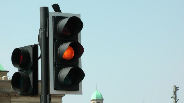 
UK road traffic lights filmed in busy city centre.