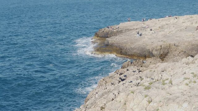 Polignano a mare, Italy, many tourists enjoy the outdoors after the quarantine from covid-19. Even fishermen resume sport fishing in the sea