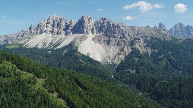 Aerial pullback of Dolomites in South Tyrol. Flying over Forest