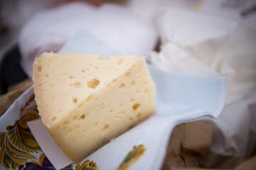 Heads of cheese. Hard cheese. Cheese. Cheese Festival. Craft cheese. A piece of hard cheese. 