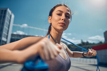 Tranquil Caucasian sportswoman with a skipping rope