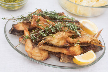 fried fish with rosemary and lemon