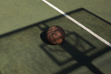 
basketball ball on a green playground in the yard