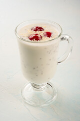 Chia yogurt pudding with coconut flakes and cherry berries.