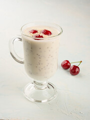 Chia yogurt pudding with coconut flakes and cherry berries.