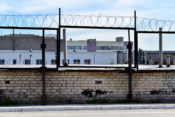 Factory zone barbed wire fence and buildings