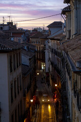 Fototapeta na wymiar Scenic rooftop view of a quiet neighborhood street at dusk in Granada, Spain