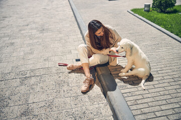 Caucasian woman looking at her cute pet