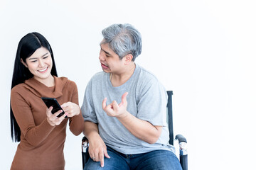 Asian husban Who is paitiant from nervous system and paralysis or hemoplegia, watching applications on a mobile phone, Which his atrractive wife are holding On white background.