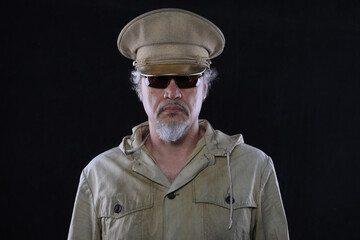 portrait of a military officer in a gold cap on a black background