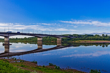 Fototapeta na wymiar bridge over the river on a calm summer evening
