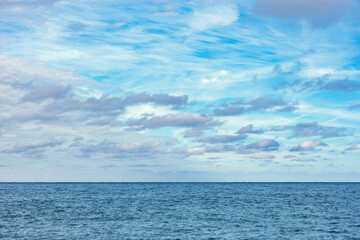 Day sky over the calm surface of the sea.