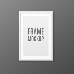 Realistic white photo frame mockup hanging on dark grey wall