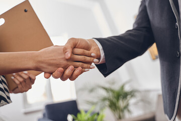 Male entrepreneur and his colleague greeting one another