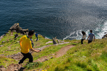 Group of young people enjoying the breathtaking view of the sea while descending