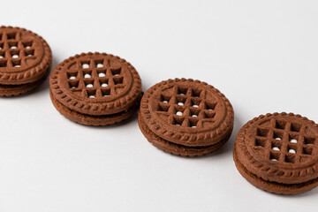 Macro photo of chocolate cookies with filling on a white background. Isolate, close up