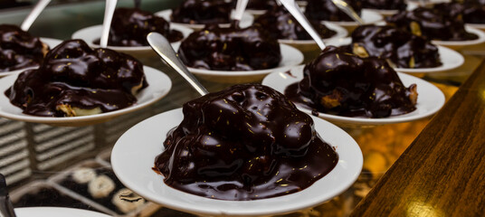 Fresh profiteroles with cream and chocolate