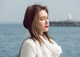 portrait of a beautiful woman at the sea with copy space. model closed eyes 