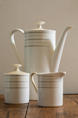 White teapot for tea on a wooden table