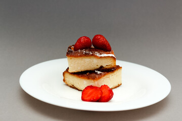 cottage cheese casserole with strawberries on a white plate