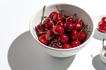 Fresh seasonal red cherries in strong sunlight