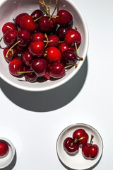 Fresh seasonal red cherries in strong sunlight