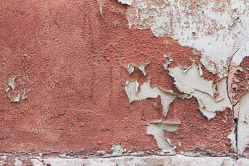 Old flaky cracked paint on gray wall, old paint background, selective focus